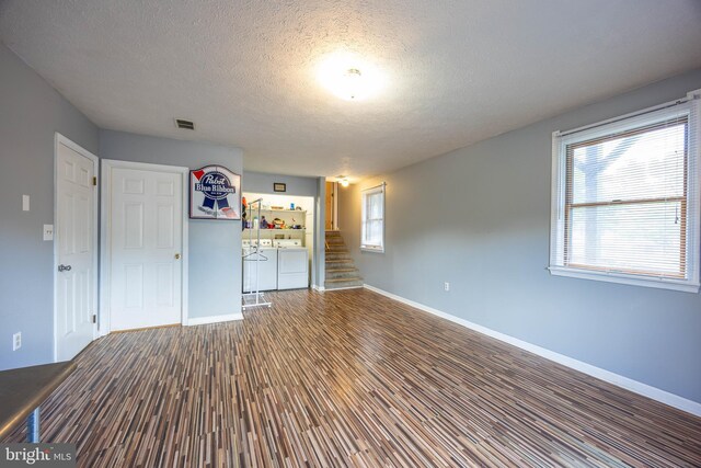 189 Columbia Dr, Kearneysville, WV 25430 - unfurnished bedroom with washing machine and dryer, wood finished floors, a textured ceiling, and baseboards