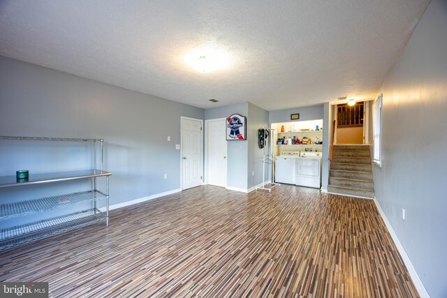 189 Columbia Dr, Kearneysville, WV 25430 - unfurnished room featuring independent washer and dryer, wood finished floors, baseboards, a textured ceiling, and stairway