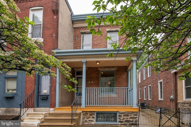 3632 Midvale Ave, Philadelphia, PA 19129 - view of front of home with brick siding, a porch, a gate, and central AC