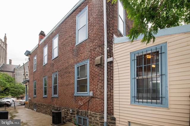 3632 Midvale Ave, Philadelphia, PA 19129 - view of side of home with central AC unit, brick siding, and fence