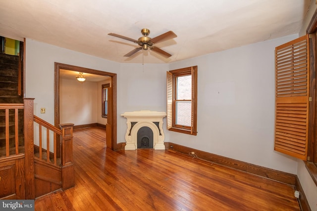 3632 Midvale Ave, Philadelphia, PA 19129 - unfurnished living room featuring hardwood / wood-style floors, stairs, ceiling fan, baseboards, and a fireplace