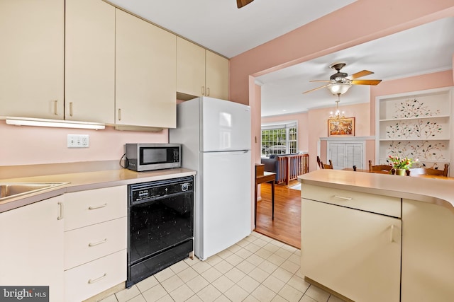 10115 Day Ave, Silver Spring, MD 20910 - kitchen with stainless steel microwave, dishwasher, freestanding refrigerator, light countertops, and ceiling fan