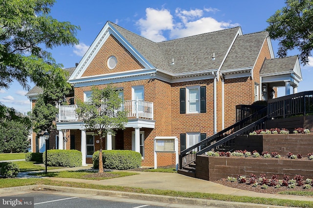 44007 Kitts Hill Ter, Ashburn, VA 20147 - colonial house with brick siding, a shingled roof, a balcony, and stairs