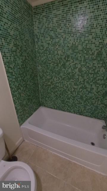 1826 W Diamond St, Philadelphia, PA 19121 - bathroom featuring tile patterned flooring, toilet, tub / shower combination, and baseboards