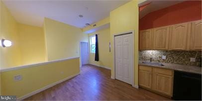 1826 W Diamond St, Philadelphia, PA 19121 - kitchen with wood finished floors, dishwasher, tasteful backsplash, a sink, and light countertops