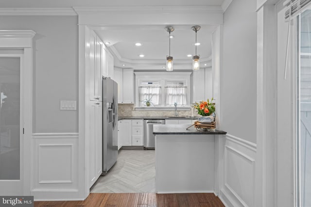 614 Maple Ave, Haddonfield, NJ 08033 - kitchen with stainless steel appliances, ornamental molding, white cabinets, decorative backsplash, and a peninsula