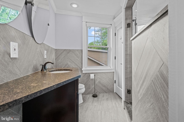 614 Maple Ave, Haddonfield, NJ 08033 - bathroom with tile walls, ornamental molding, vanity, toilet, and a wainscoted wall