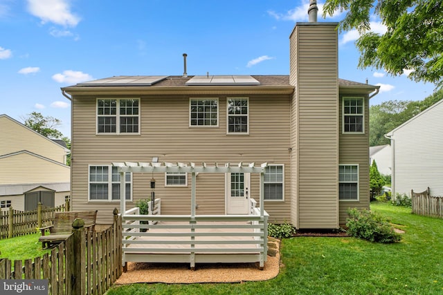 7481 Windswept Ct, Sykesville, MD 21784 - back of house with roof mounted solar panels, a pergola, a chimney, and a deck