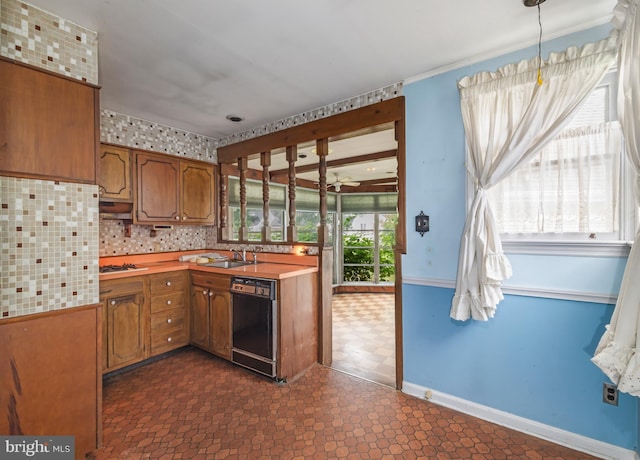 364 Driscoll Ave, Woodbury, NJ 08096 - kitchen featuring dishwasher, a sink, brown cabinetry, light countertops, and baseboards