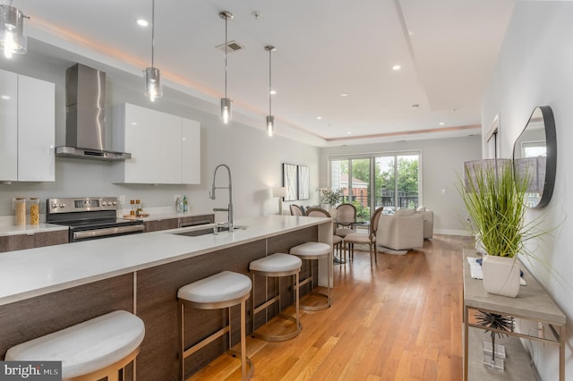 1125 Morse St NE Unit 2, Washington, DC 20002 - kitchen featuring stainless steel electric range, wall chimney range hood, modern cabinets, a sink, and light countertops