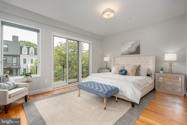 1125 Morse St NE Unit 2, Washington, DC 20002 - bedroom with multiple windows, wood finished floors, access to outside, and baseboards