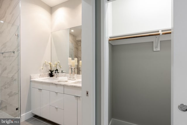 1125 Morse St NE Unit 2, Washington, DC 20002 - bathroom with a stall shower, double vanity, baseboards, and tile patterned flooring