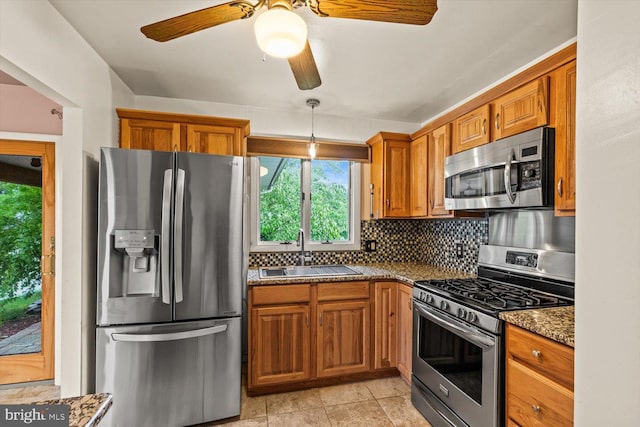 129 Henry Rd, Enola, PA 17025 - kitchen featuring stainless steel appliances, a sink, brown cabinetry, and decorative backsplash