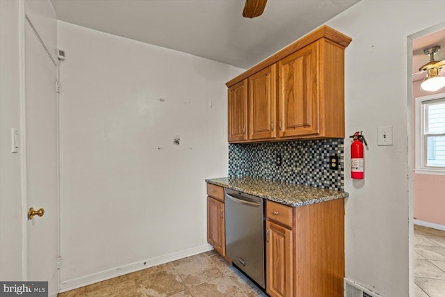 129 Henry Rd, Enola, PA 17025 - kitchen with brown cabinetry, backsplash, and dark stone countertops
