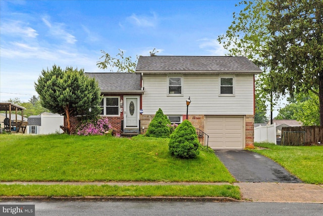129 Henry Rd, Enola, PA 17025 - split level home with a garage, asphalt driveway, roof with shingles, and brick siding