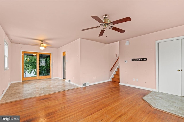 129 Henry Rd, Enola, PA 17025 - unfurnished living room with a ceiling fan, stairway, light wood-type flooring, and baseboards