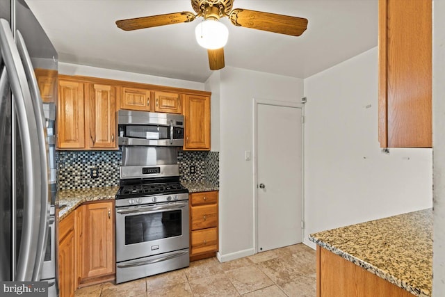 129 Henry Rd, Enola, PA 17025 - kitchen with stainless steel appliances, backsplash, a ceiling fan, light stone countertops, and brown cabinetry