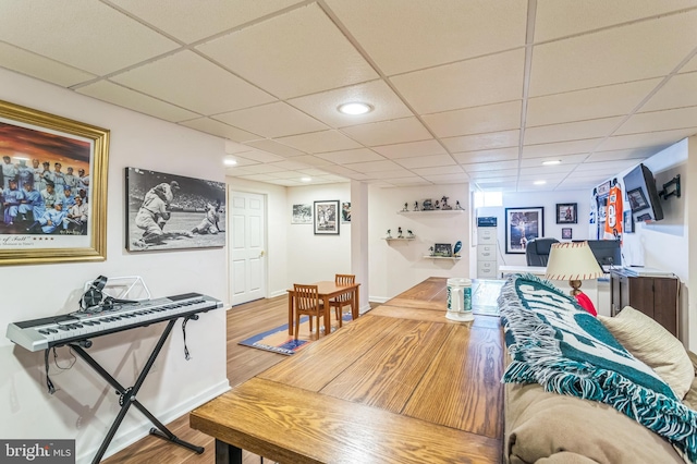 living room with wood finished floors, a paneled ceiling, and recessed lighting
