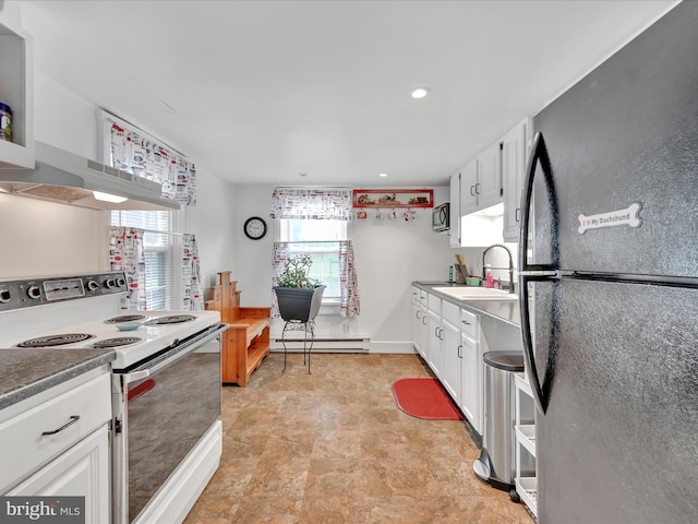 kitchen featuring freestanding refrigerator, white range with electric stovetop, a baseboard radiator, a sink, and white cabinetry