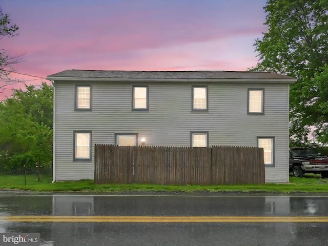 property exterior at dusk with fence