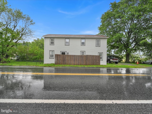 view of home's exterior featuring fence