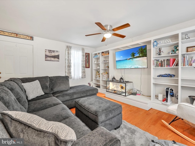 living room with a ceiling fan and wood finished floors