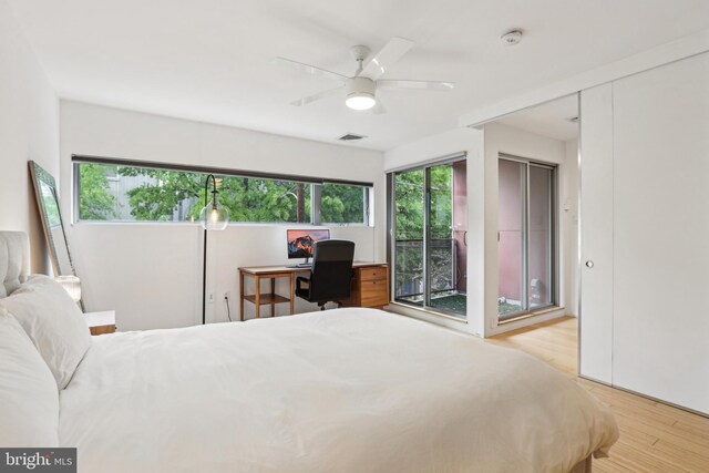 955 N American St, Philadelphia, PA 19123 - bedroom with wood finished floors, access to exterior, an office area, and a ceiling fan