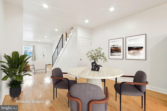 dining room featuring stairway, light wood finished floors, baseboards, and recessed lighting