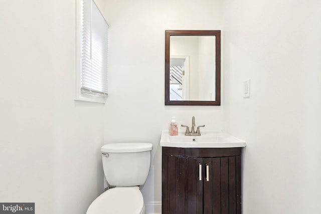 half bath with vanity and toilet