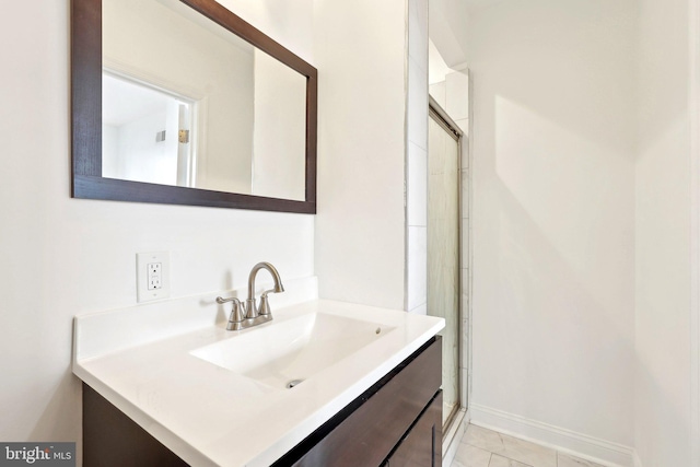 full bathroom with vanity and a shower with door