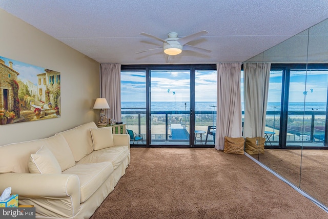 10900 Coastal Hwy Unit 209, Ocean City, MD 21842 - carpeted living area with floor to ceiling windows, ceiling fan, a textured ceiling, and a water view