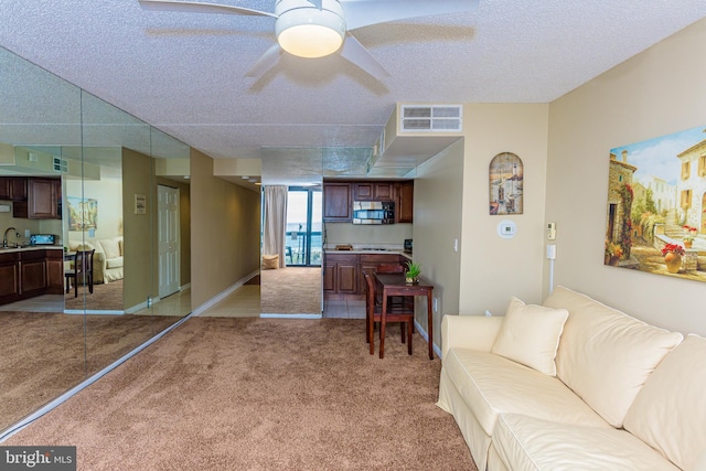 10900 Coastal Hwy Unit 209, Ocean City, MD 21842 - living area featuring light carpet, a textured ceiling, and ceiling fan