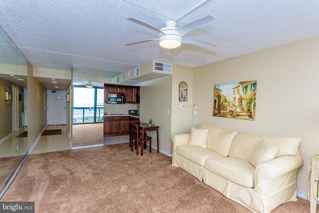 10900 Coastal Hwy Unit 209, Ocean City, MD 21842 - living room with a ceiling fan, light carpet, baseboards, and a textured ceiling