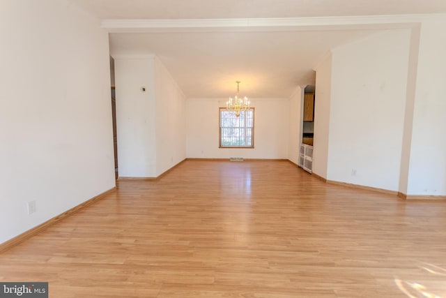 186 Hampton Dr, Chambersburg, PA 17202 - unfurnished room featuring a chandelier, light wood-type flooring, ornamental molding, and baseboards