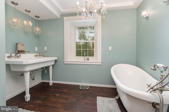 1554 Williams Grove Rd, Mechanicsburg, PA 17055 - bathroom with a chandelier, a soaking tub, wood-type flooring, and baseboards