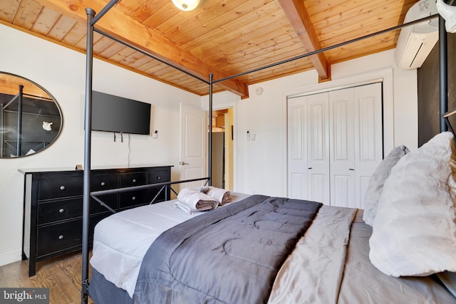 bedroom featuring wood ceiling, a wall unit AC, wood finished floors, beamed ceiling, and a closet