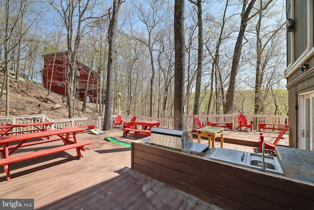 wooden deck featuring outdoor dining space