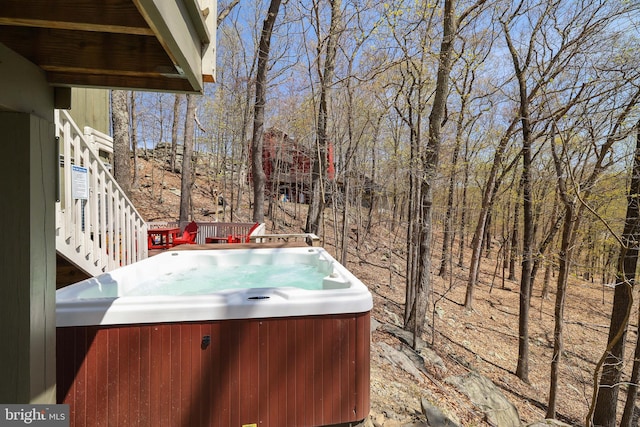 view of yard with a hot tub and stairway