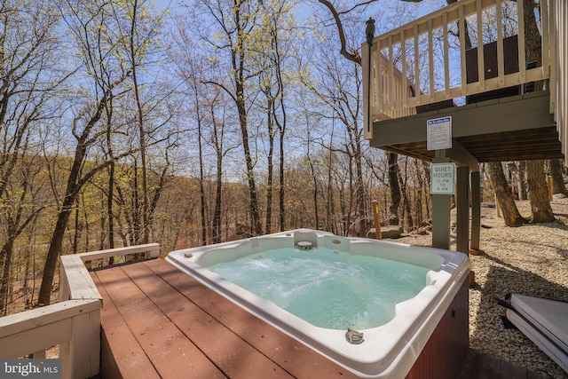 wooden deck featuring an outdoor hot tub