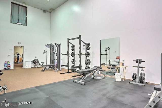 gym with a towering ceiling