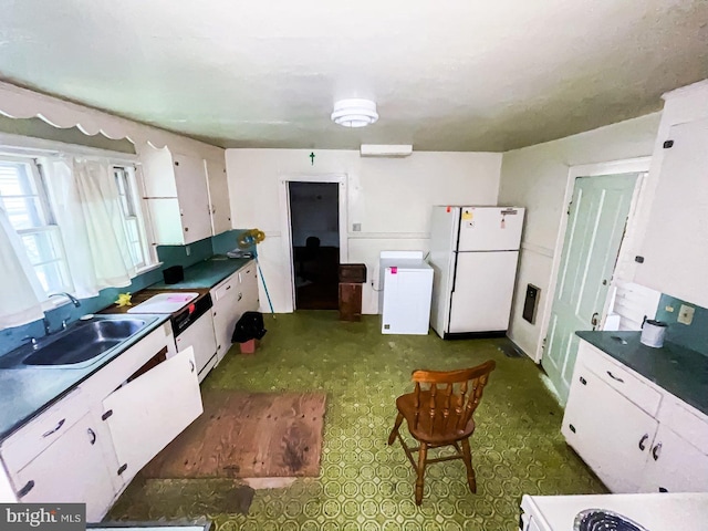 22446E Depot St, Newsoms, VA 23874 - kitchen featuring freestanding refrigerator, a sink, fridge, white cabinets, and dark countertops