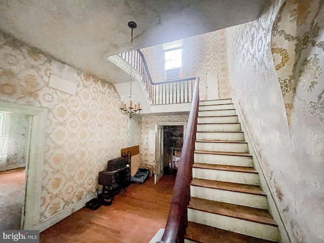 22446E Depot St, Newsoms, VA 23874 - staircase with wallpapered walls, wood finished floors, and baseboards