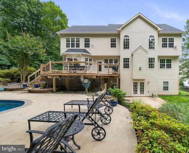 3740 Devin Ct, Huntingtown, MD 20639 - back of property with a deck, a patio, french doors, and an outdoor pool