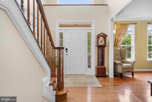3740 Devin Ct, Huntingtown, MD 20639 - entryway with hardwood / wood-style floors, stairway, baseboards, ornamental molding, and a towering ceiling