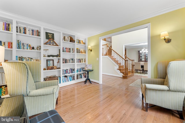 3740 Devin Ct, Huntingtown, MD 20639 - living area featuring a chandelier, wood finished floors, stairs, crown molding, and built in features