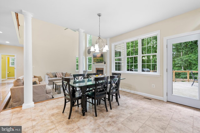 3740 Devin Ct, Huntingtown, MD 20639 - dining room featuring ornate columns, baseboards, a chandelier, a glass covered fireplace, and recessed lighting