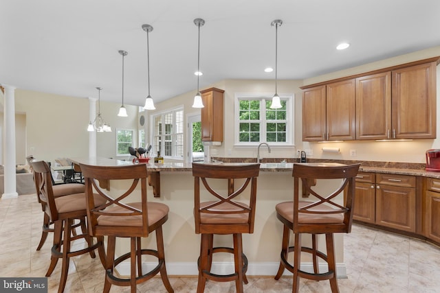 3740 Devin Ct, Huntingtown, MD 20639 - kitchen featuring a kitchen breakfast bar, decorative light fixtures, recessed lighting, brown cabinets, and stone countertops