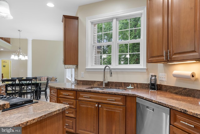3740 Devin Ct, Huntingtown, MD 20639 - kitchen with dishwasher, a sink, brown cabinetry, dark stone counters, and decorative light fixtures