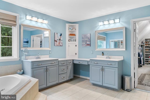 3740 Devin Ct, Huntingtown, MD 20639 - bathroom featuring two vanities, a garden tub, tile patterned flooring, and a walk in closet