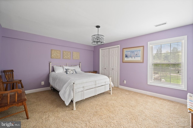 3740 Devin Ct, Huntingtown, MD 20639 - bedroom featuring a chandelier, baseboards, light carpet, and a closet